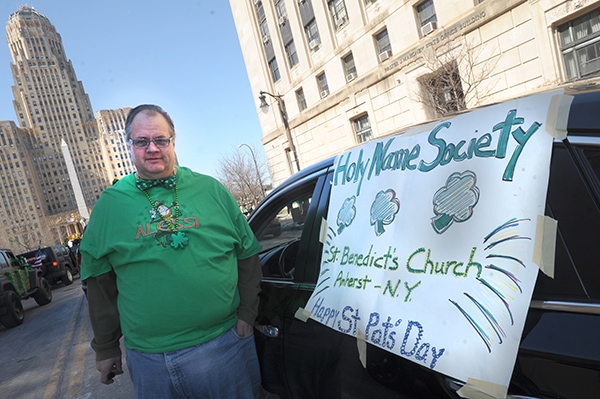 Christopher Alessi, of St. Benedict's Parish, prepares to march in the City of Buffalo Annual St. Patrick's Day Parade on Delaware Avenue.  (Dan Cappellazzo/Staff Photographer)